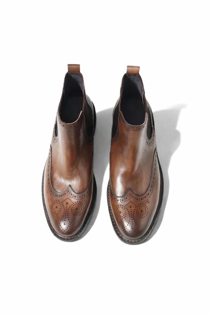 Men’s leather brogue Chelsea boots with wingtip detailing and classic slip-on ankle boot silhouette top view