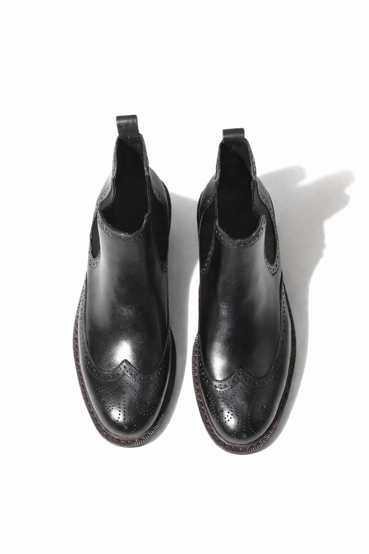 Men’s leather brogue Chelsea boots in black with wingtip detailing and classic slip-on ankle boot silhouette top view