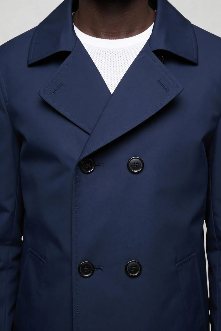 Men’s navy double breasted trench coat close-up