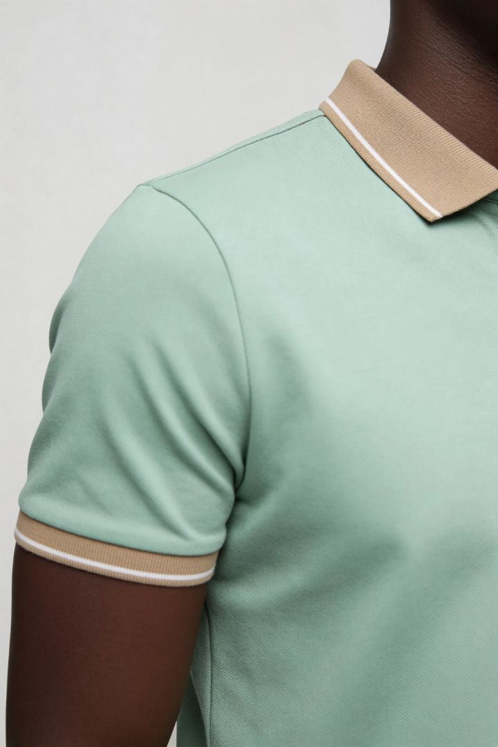 Men’s tailored summer polo shirt with contrast collar and breathable stretch fabric for modern casual style in sage green close-up