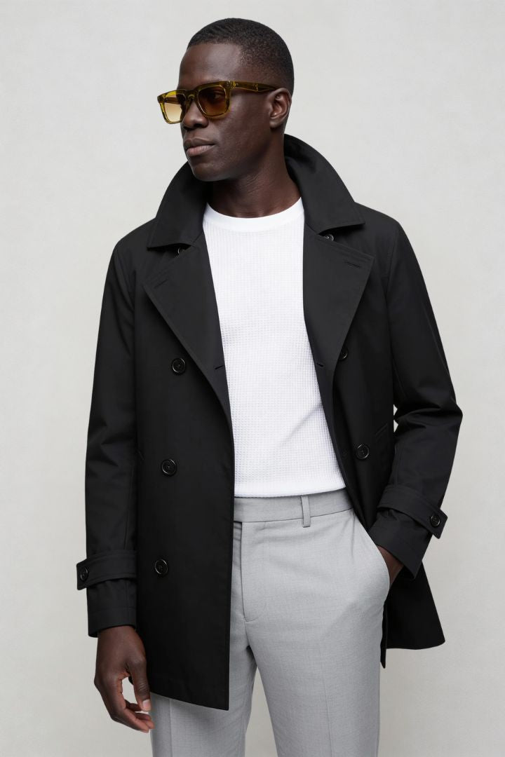 Men’s black double breasted trench coat front view posing