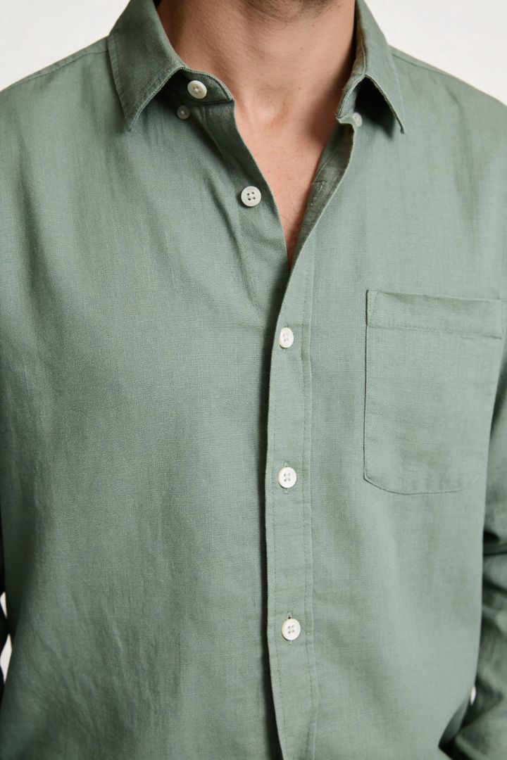 Men’s sage green linen resort set with relaxed linen shirt and drawstring pants lightweight summer outfit close-up