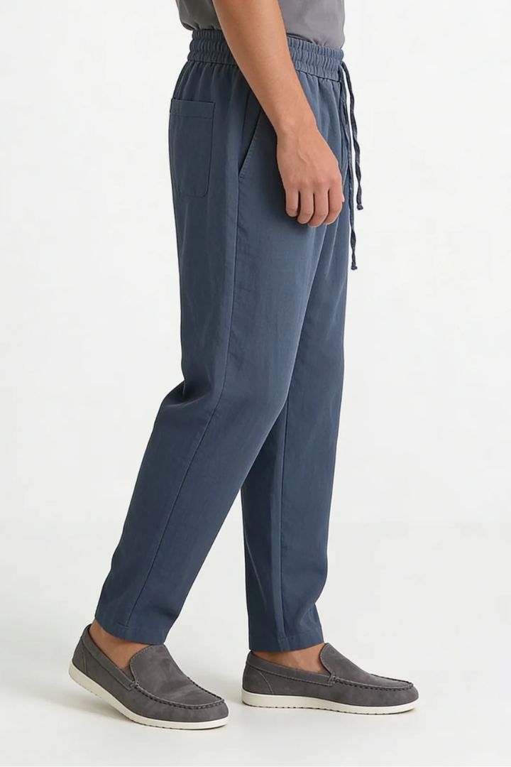Men wearing steel blue linen drawstring trousers relaxed straight fit lightweight summer linen pants side view