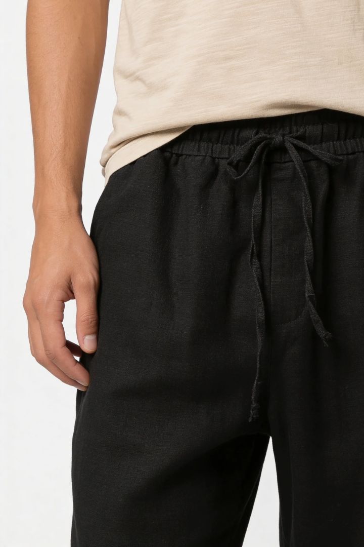 Men wearing black linen drawstring trousers relaxed straight fit lightweight summer linen pants close-up