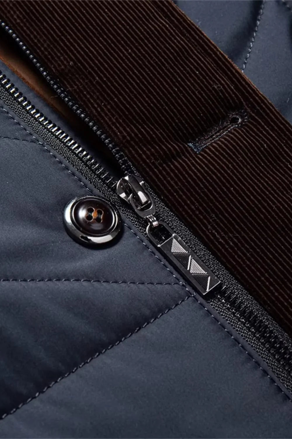 Close-up of a blue jacket with a zipper and button detail