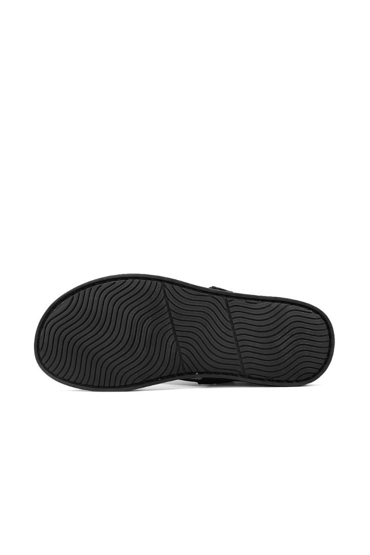 Men’s black cross-strap leather slide sandals with cowhide upper and stitched footbed design close-up