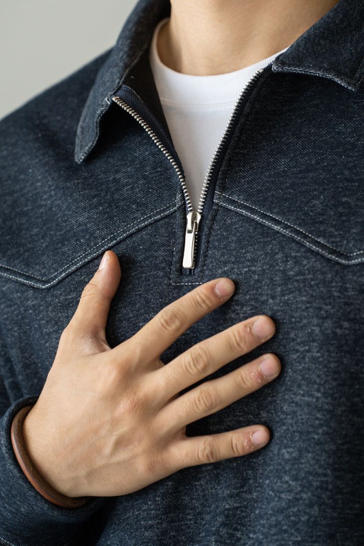 Men’s navy cotton quarter zip sweater with structured collar and ribbed cuffs close up