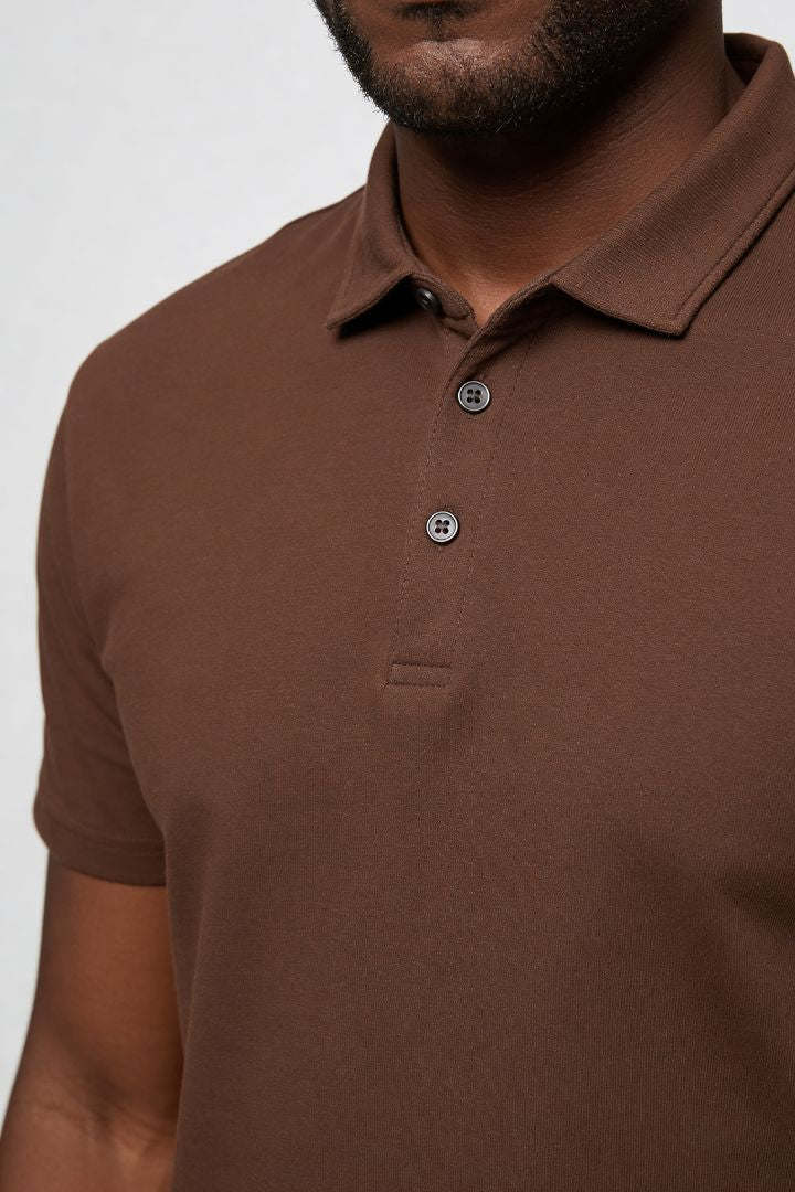 Men’s brown cotton polo shirt with modern slim fit and short sleeves close-up