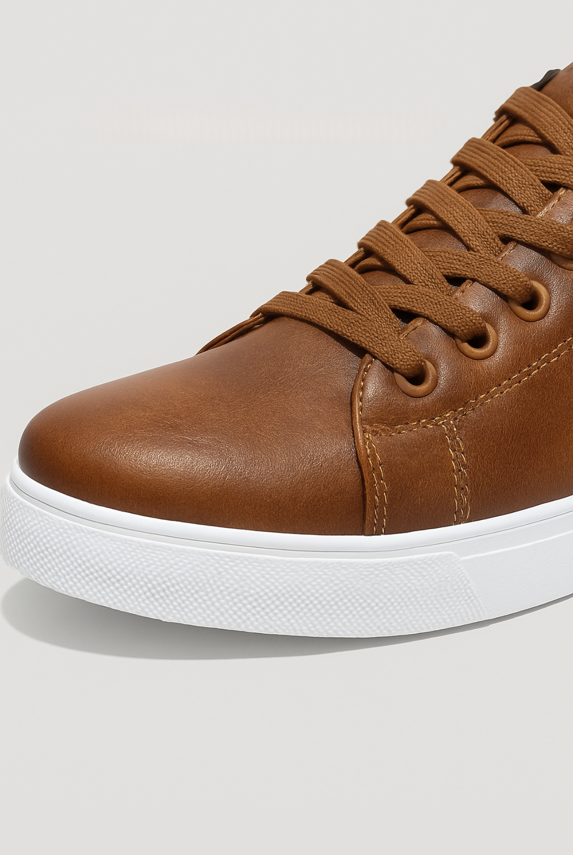 Brown leather sneaker with white sole on a light gray background