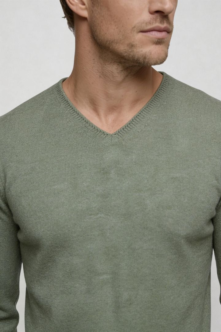 Men’s green lightweight V-neck knit sweater with ribbed cuffs and clean slim silhouette close-up