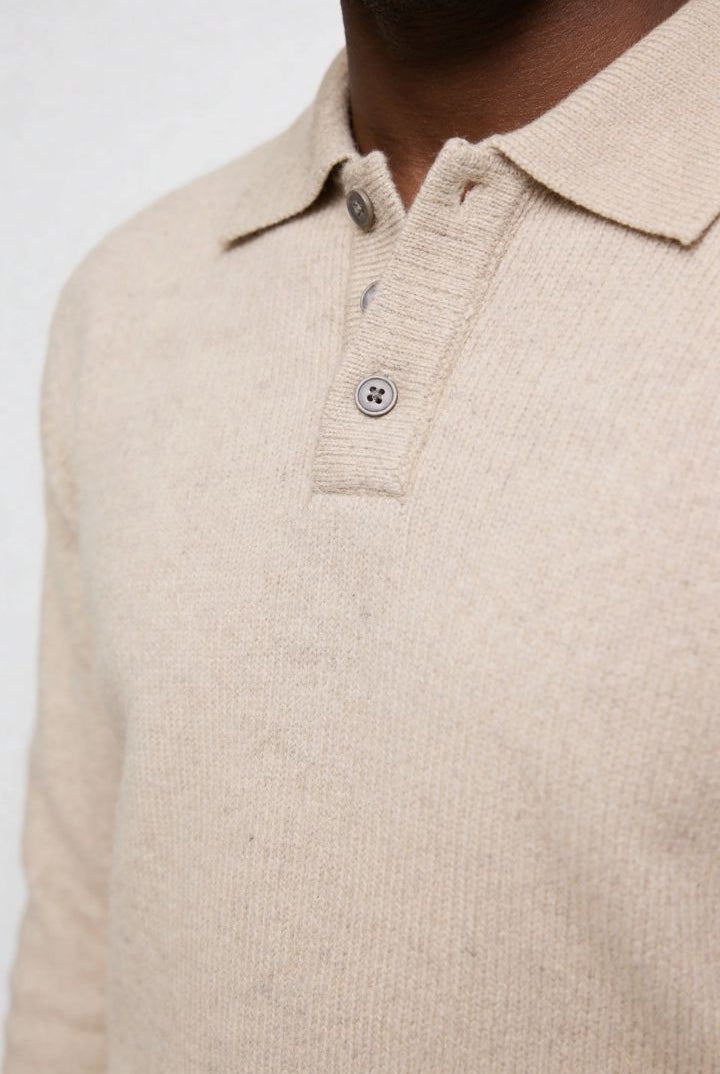 Men’s slim fit long sleeve knit polo with textured fabric and modern collar close up