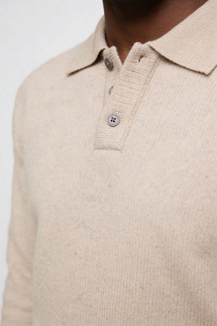 Men’s slim fit long sleeve knit polo with textured fabric and modern collar close up
