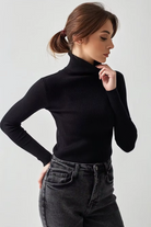 Side view of fitted black turtleneck knit top with long sleeves
