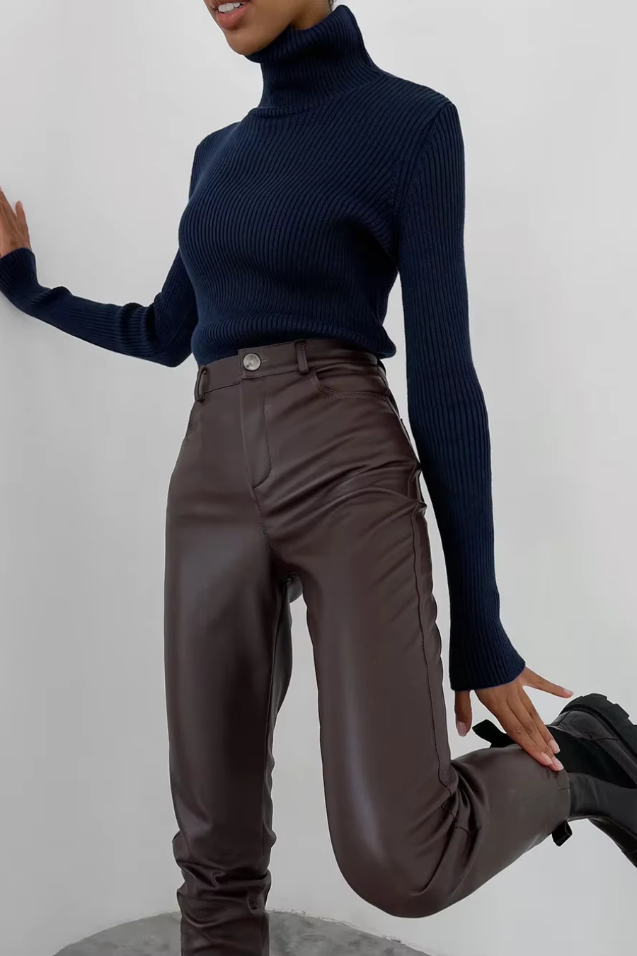 Woman wearing navy ribbed turtleneck sweater, slim fit long sleeve