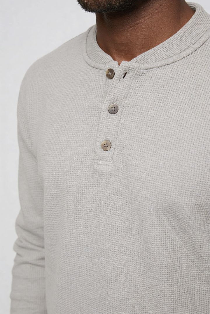 Men’s slim fit long sleeve henley shirt in cotton waffle knit texture close up