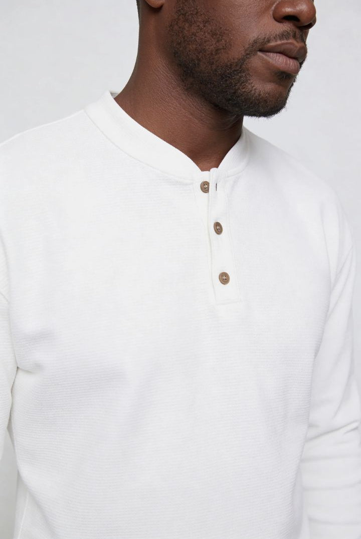Men’s slim fit long sleeve henley shirt in cotton waffle knit texture close up