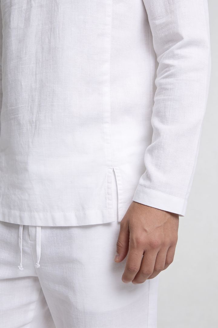 Men’s white linen polo shirt and linen pants summer outfit set with relaxed tailored fit close-up