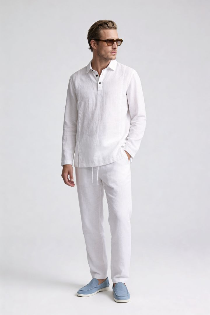 Men’s white linen polo shirt and linen pants summer outfit set with relaxed tailored fit pose