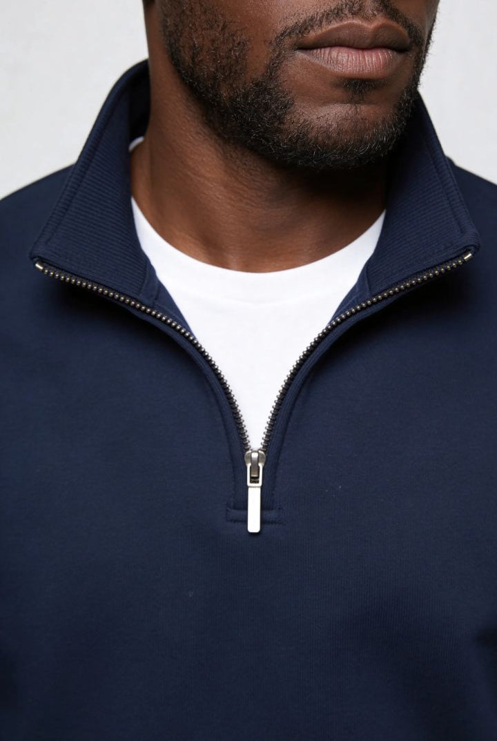 Men’s navy quarter zip cotton sweater with tailored slim fit and metal zipper detail close up