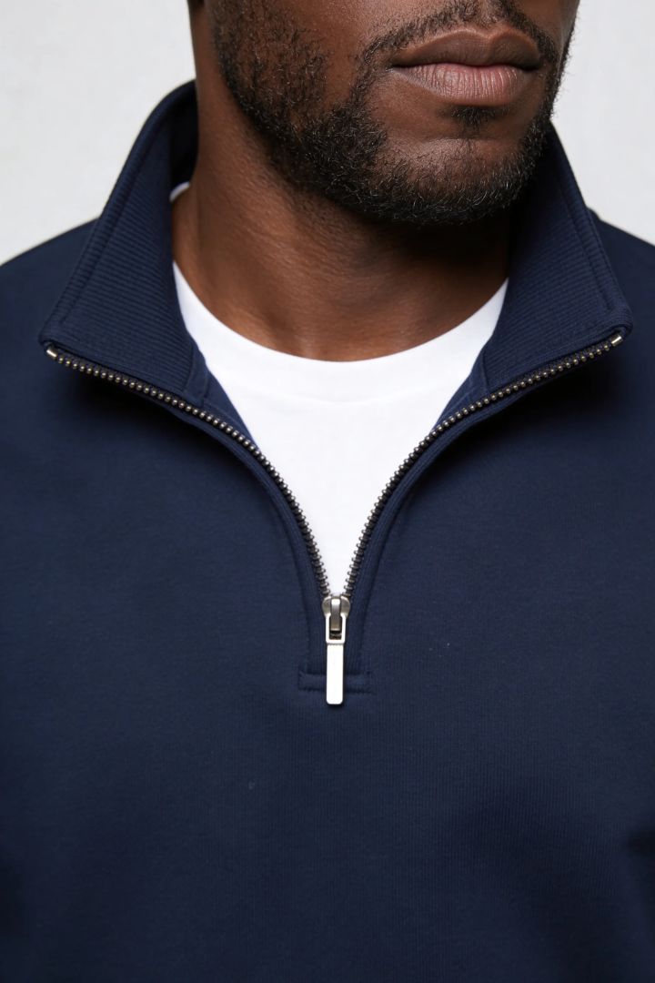Men’s navy quarter zip cotton sweater with tailored slim fit and metal zipper detail close up