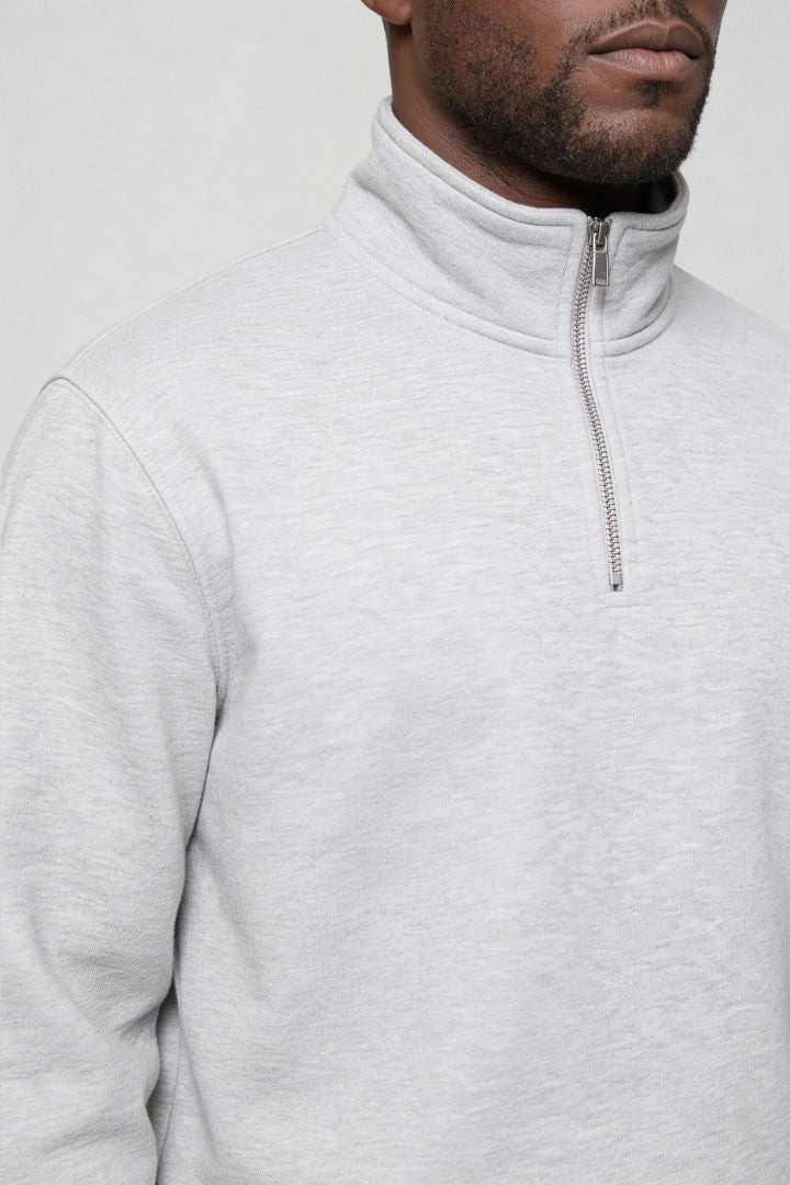 Men’s navy quarter zip cotton sweater with tailored slim fit and metal zipper detail close up