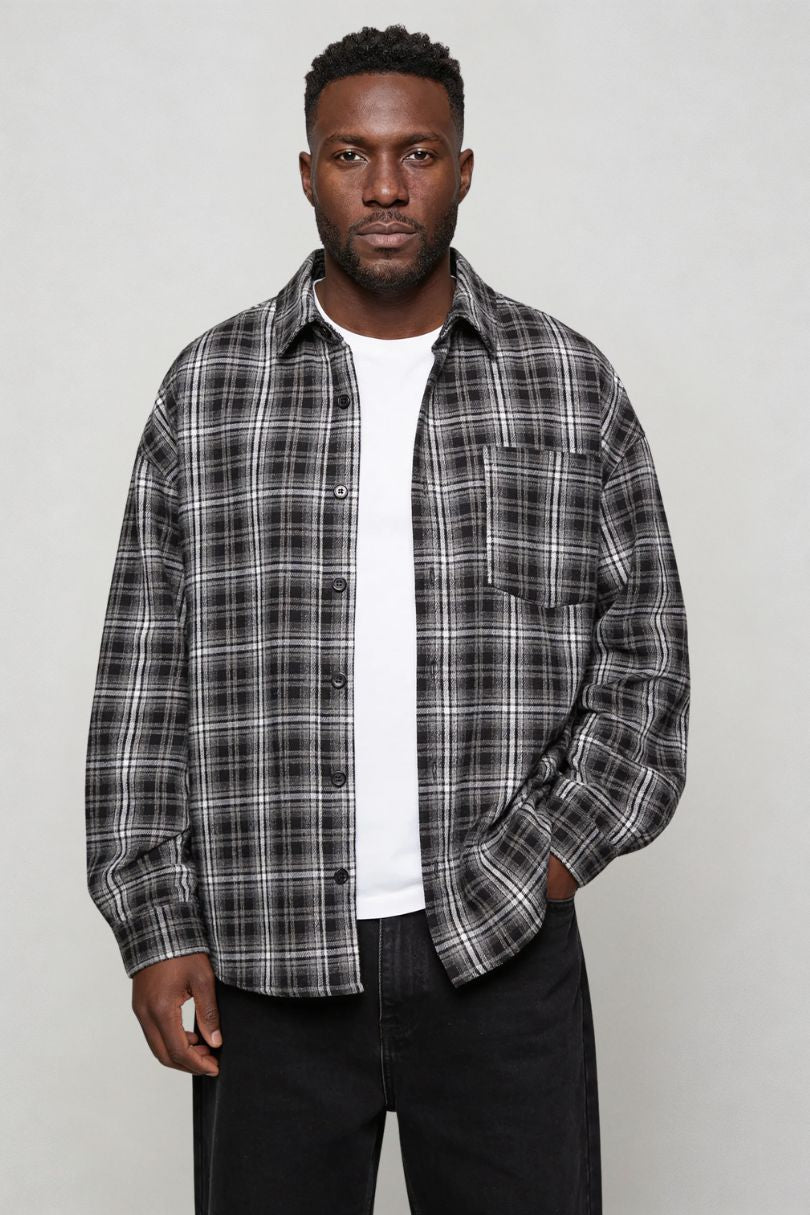 Men's black plaid button shirt worn as casual overshirt front side