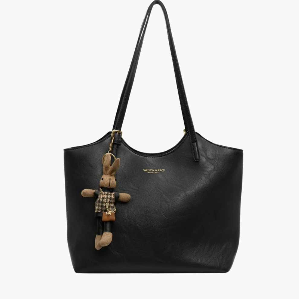 Luna women’s faux-leather shoulder tote bag in black with zip-top and gold hardware on white background
