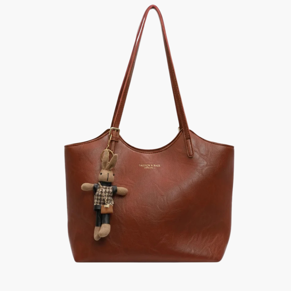 Luna women’s faux-leather shoulder tote bag in chestnut brown with zip-top and gold hardware on white background