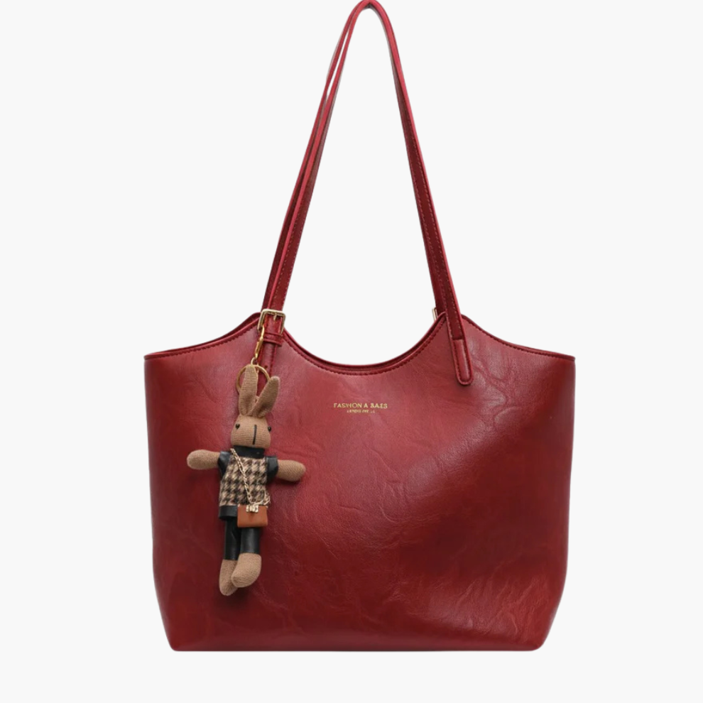 Luna women’s tote handbag in wine red with zip-top and bunny charm on white background