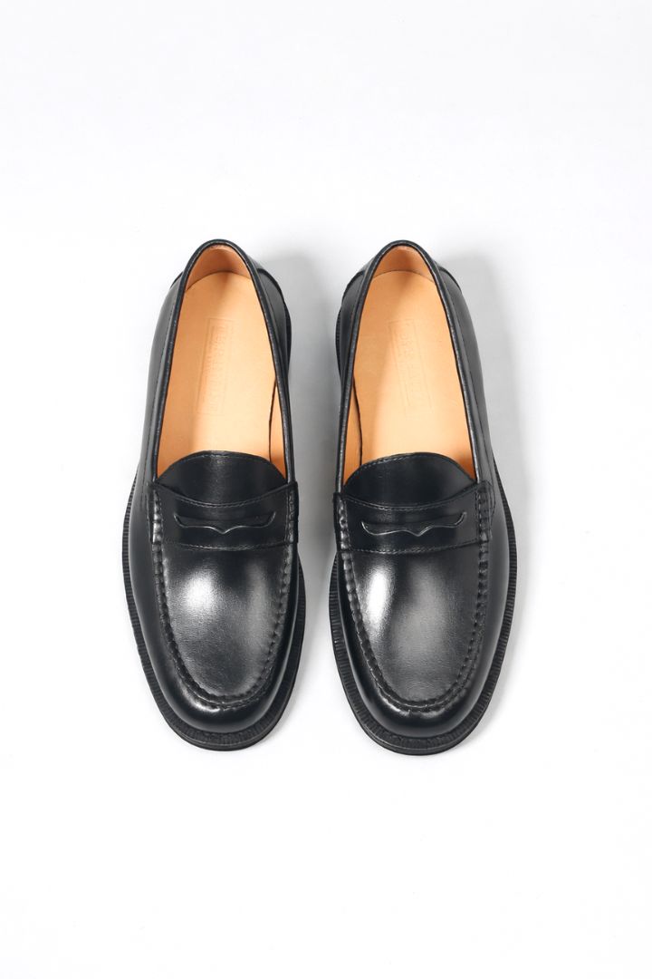 Premium men’s leather penny loafers with classic slip-on silhouette and refined stitching detail top view