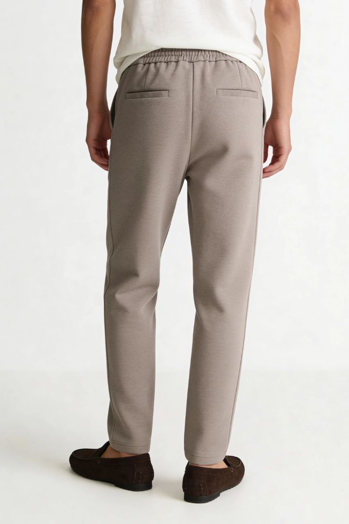 Men’s wool blend drawstring trousers in sand taupe – back view