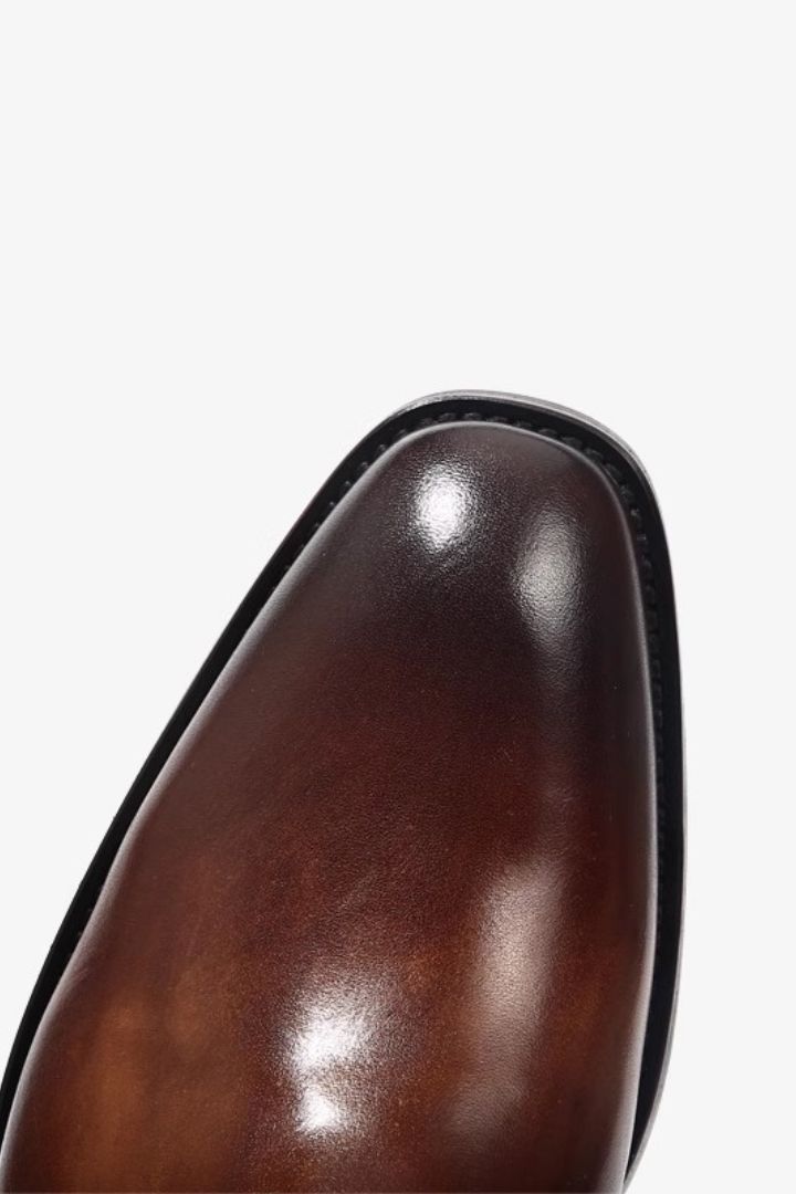 Premium men’s leather Chelsea boots in brown with elastic side panels and sleek slip-on ankle boot design close-up