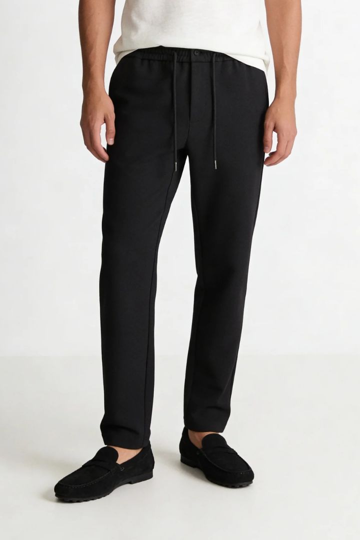 Men’s wool blend drawstring trousers in jet black – front view shot