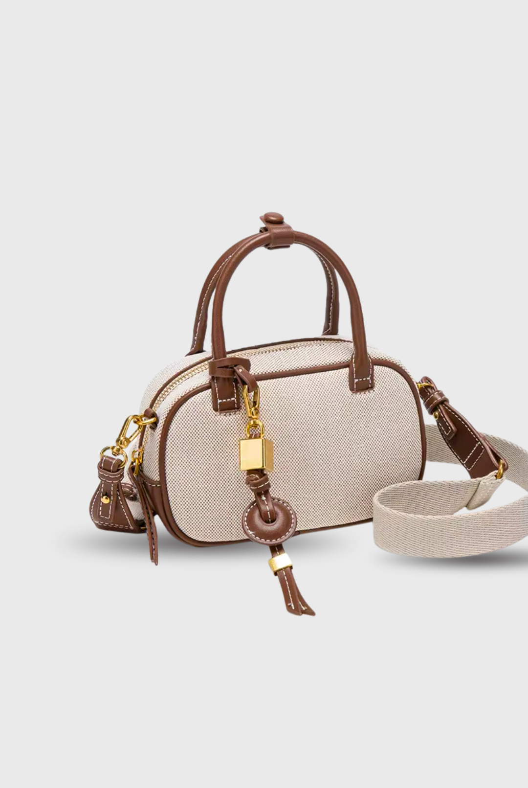 Beige handbag with brown accents on a light gray background