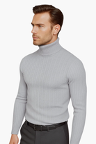 Man wearing a gray turtleneck sweater on a white background