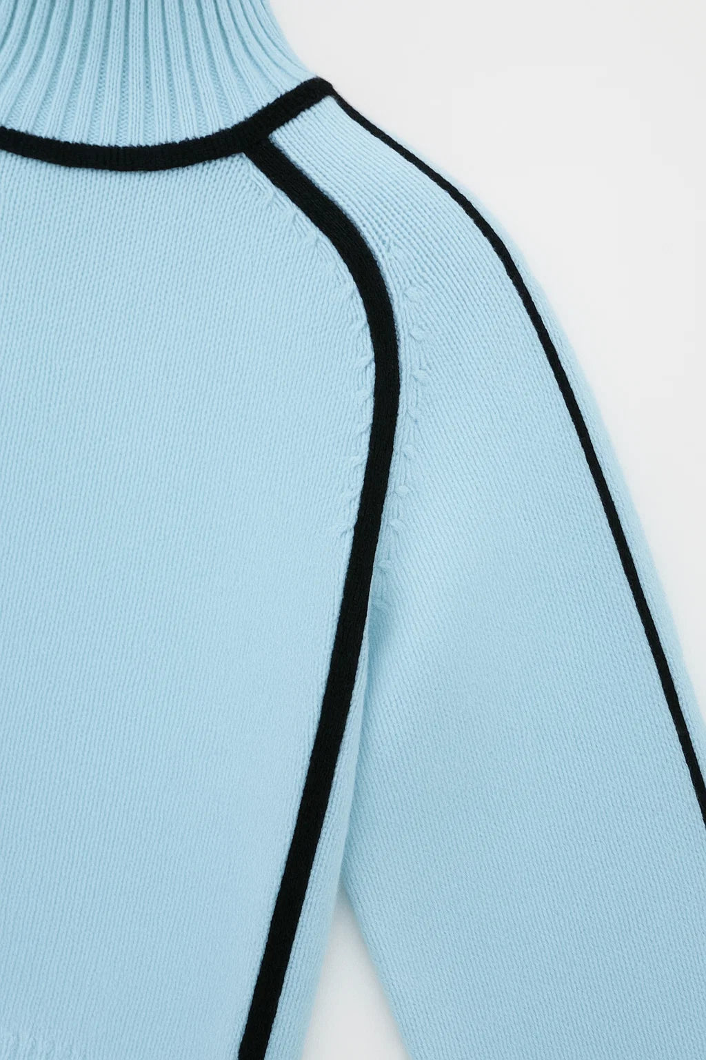 Light blue sweater with black trim on a white background