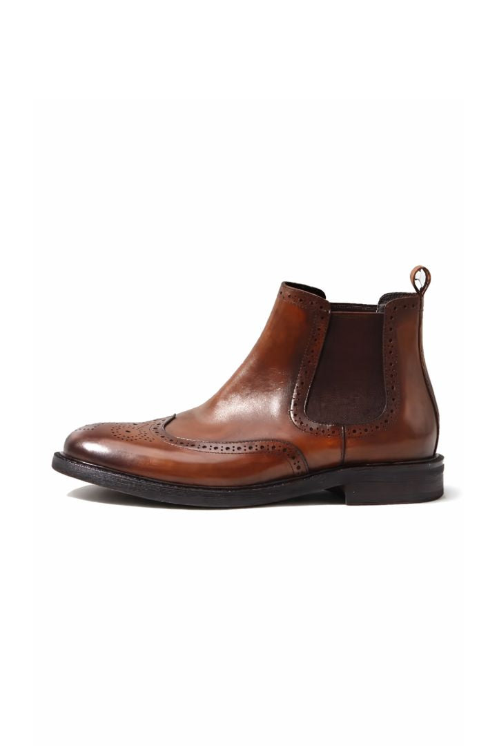 Men’s leather brogue Chelsea boots in brown with wingtip detailing and classic slip-on ankle boot silhouette side view