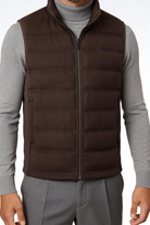 Man wearing the brown insulated puffer vest of Lavencio