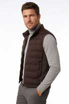 Man wearing the brown insulated puffer vest of Lavencio