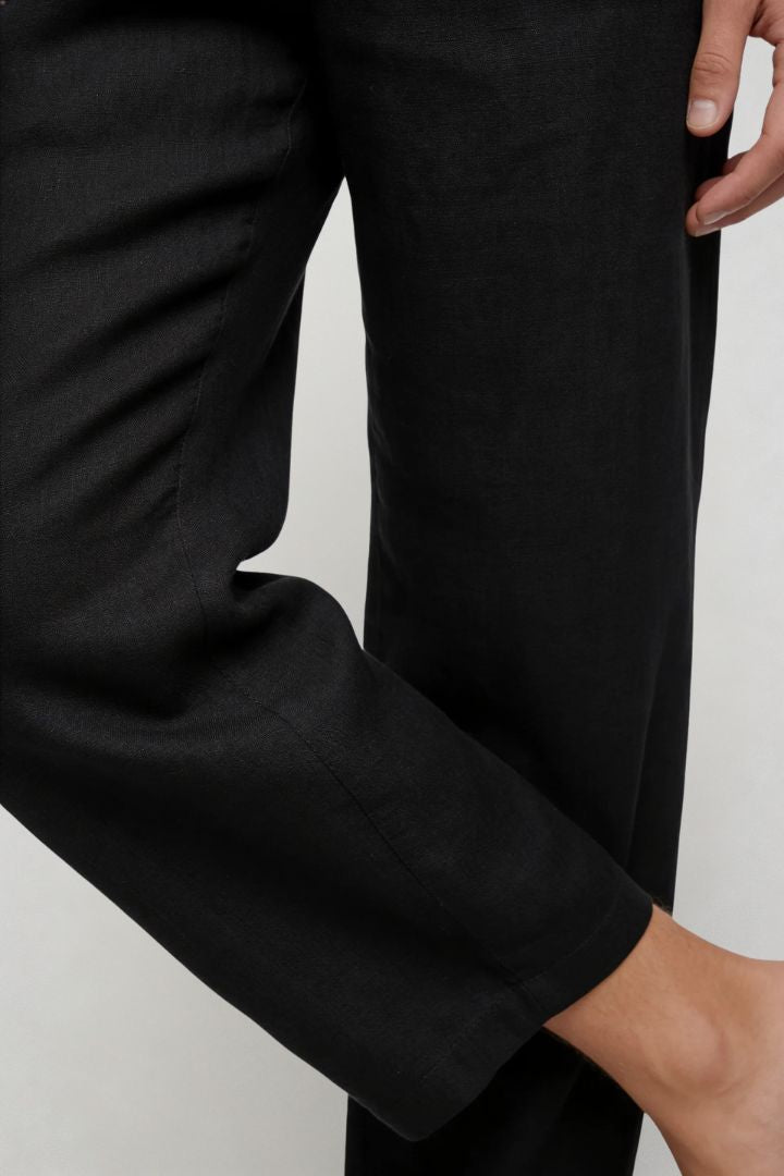 Men’s black linen resort set with relaxed linen shirt and drawstring pants lightweight summer outfit close-up pant detail