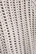 Close-up of a beige crochet vest