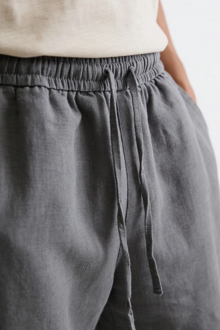 Men wearing gray linen drawstring trousers relaxed straight fit lightweight summer linen pants close-up
