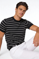 Man wearing the Blake Striped Lyocell T-Shirt with a clean striped design and lightweight fabric in a studio setting.