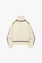 Cream-colored sweater with black accents on a white background