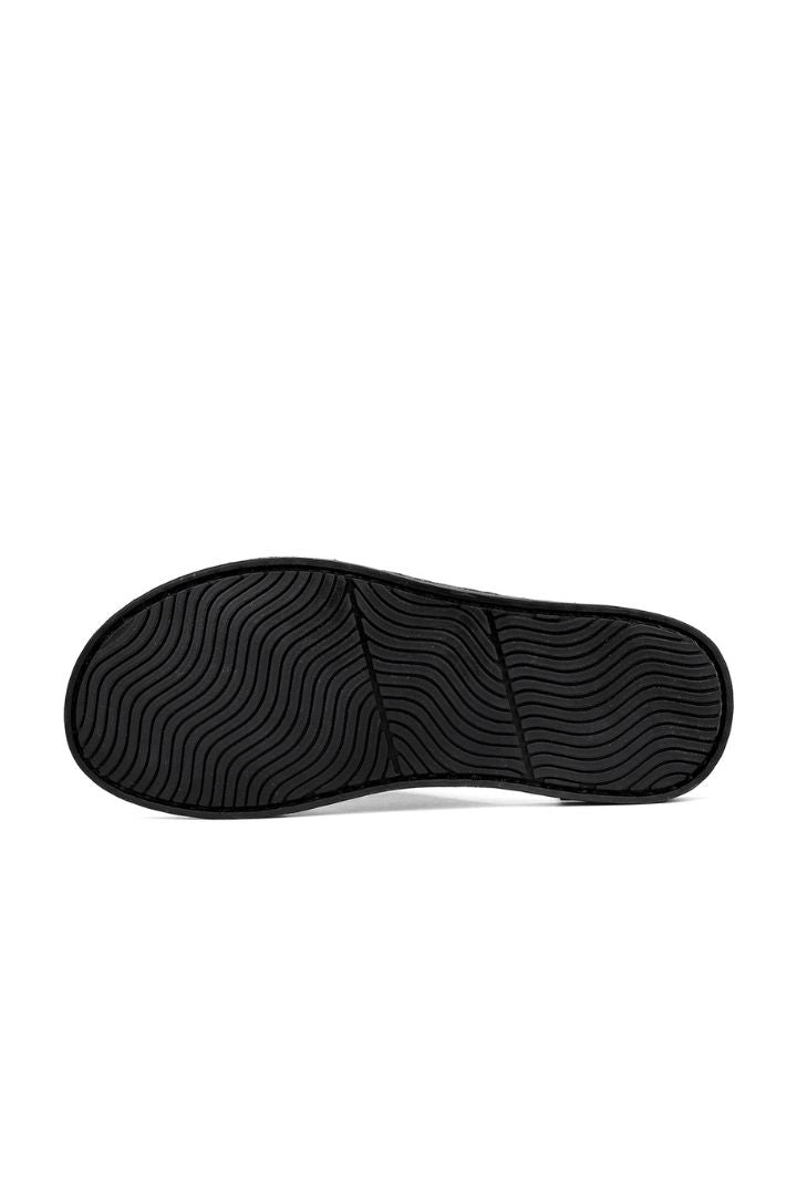 Men’s black timeless leather slide sandals with cowhide upper and stitched sole design under view