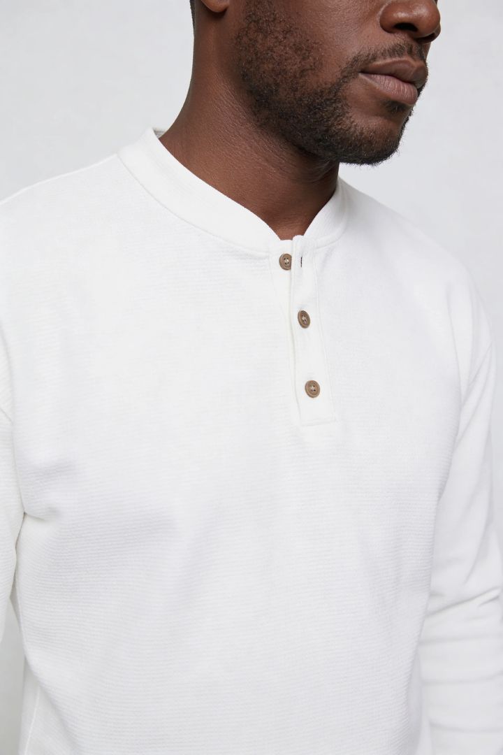 Men’s slim fit long sleeve henley shirt in cotton waffle knit texture close up