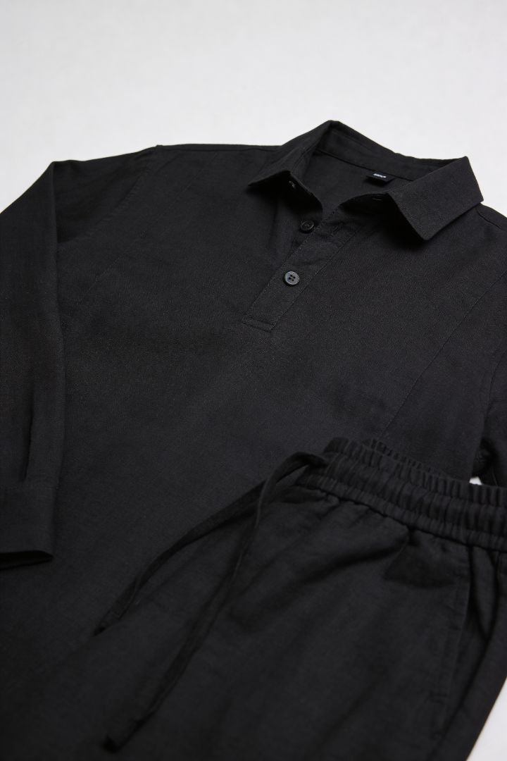 Men’s black linen polo shirt and linen pants summer outfit set with relaxed tailored fit product shoot
