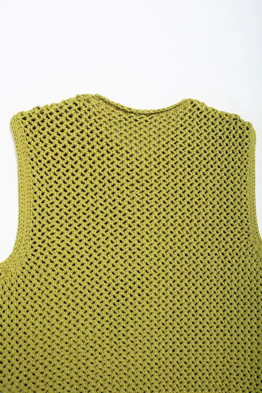 Details green knitted vest on a white background