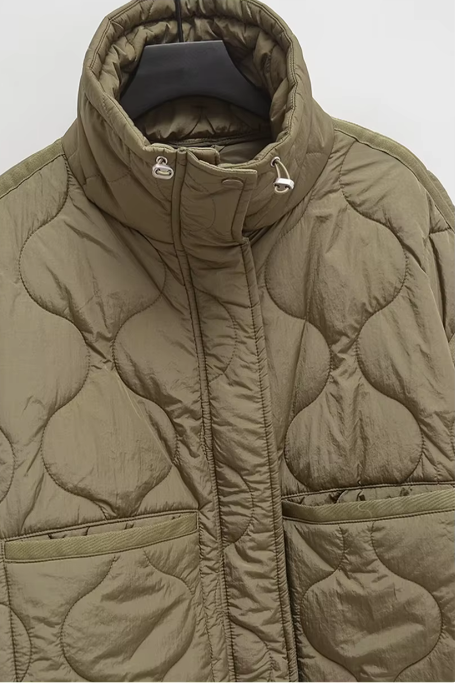 Textured wave quilt stitching on olive women’s puffer coat