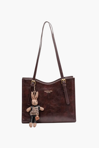 Women’s brown vegan-leather shoulder bag—medium tote with long straps, front view.